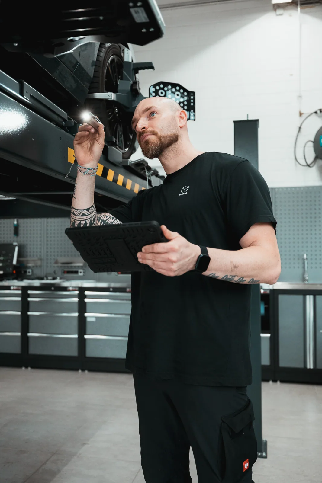 Servicemitarbeiter mit Tablet an der Hebebühne